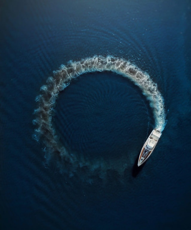 A boat driving in circles in a body of water