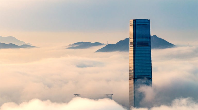 A skyscraper surrounded by fog