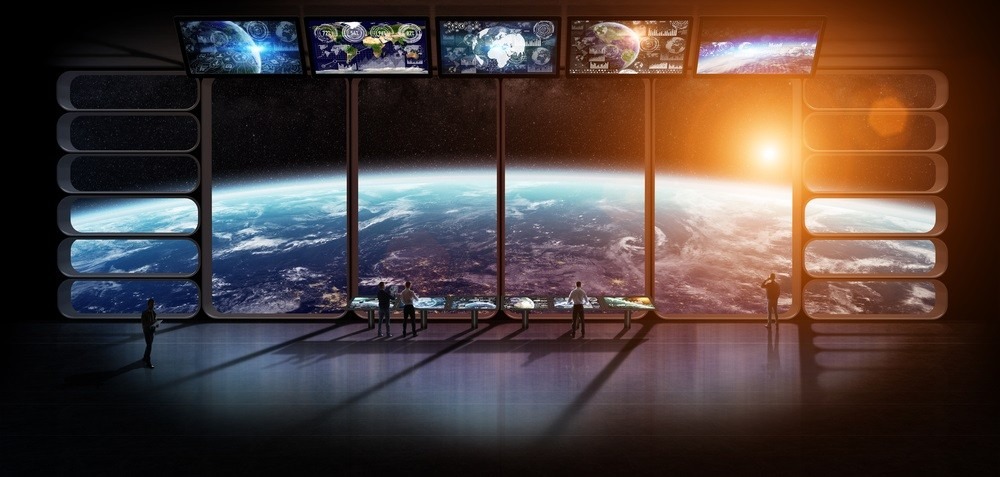 Several people standing in futuristic building, overlooking planet Earth.