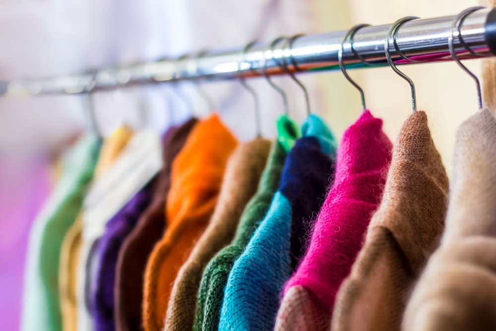 Close-up view of colorful rack of clothes 
