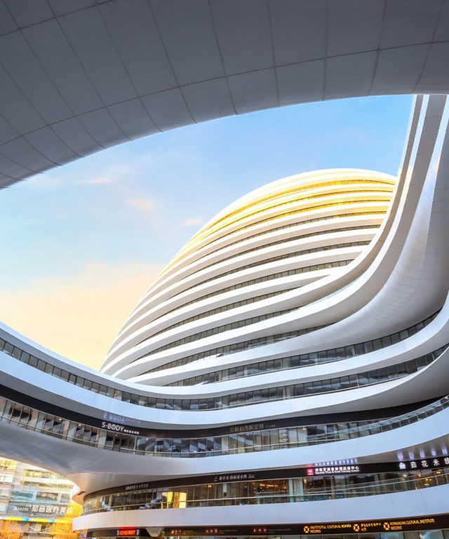 Large white building shaped like an oval with many windows