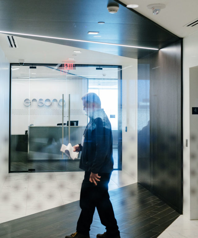 A man walking in the Ensono office