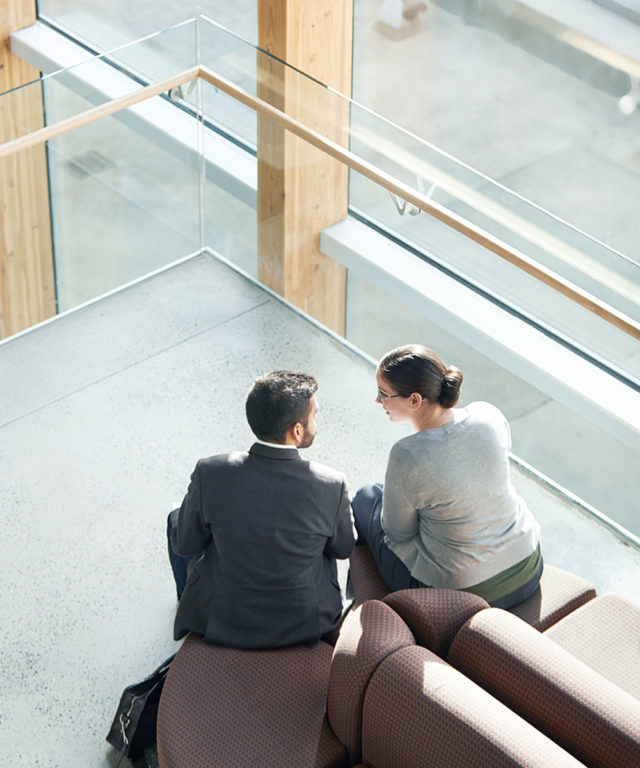 Overhead view of a man and woman sitting on a couch and talking
