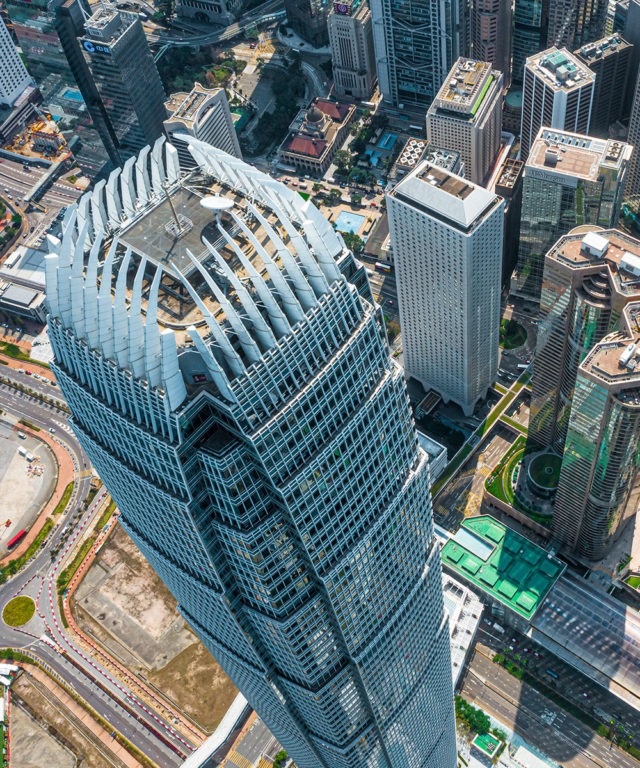 Overhead view of a skyscraper with other city landscape surrounding