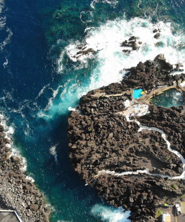 Waves crashing against a rock island