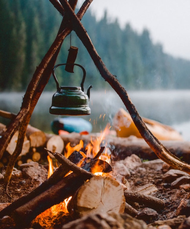A kettle hanging over a campfire