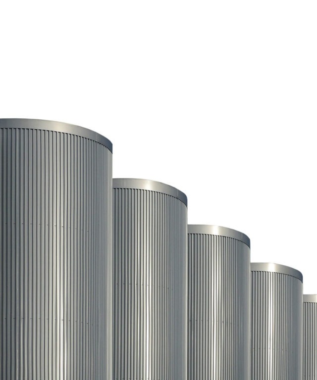 Four grey cylinders with ridges on the sides in a row