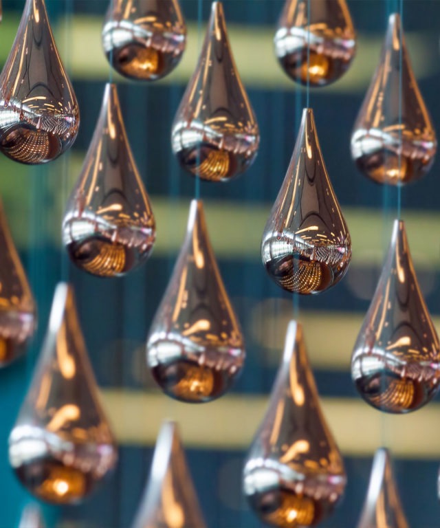 Close-up view of hanging objects that are mettalic and shaped like water droplets