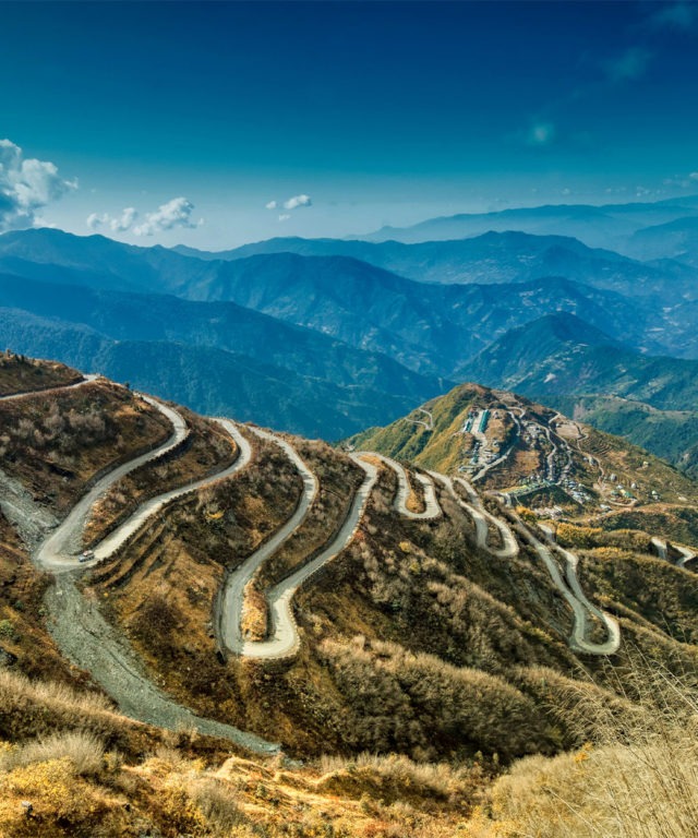 Mountains and hills with winding roads paved into the side