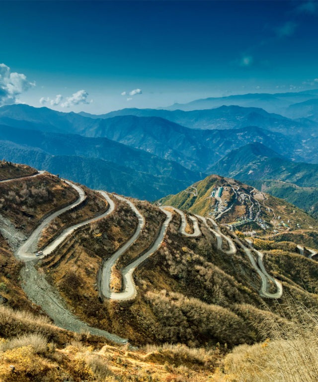 Mountains and hills with winding roads paved into the side