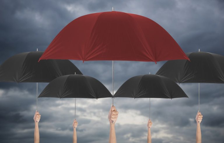 Five people holding up five umbrellas