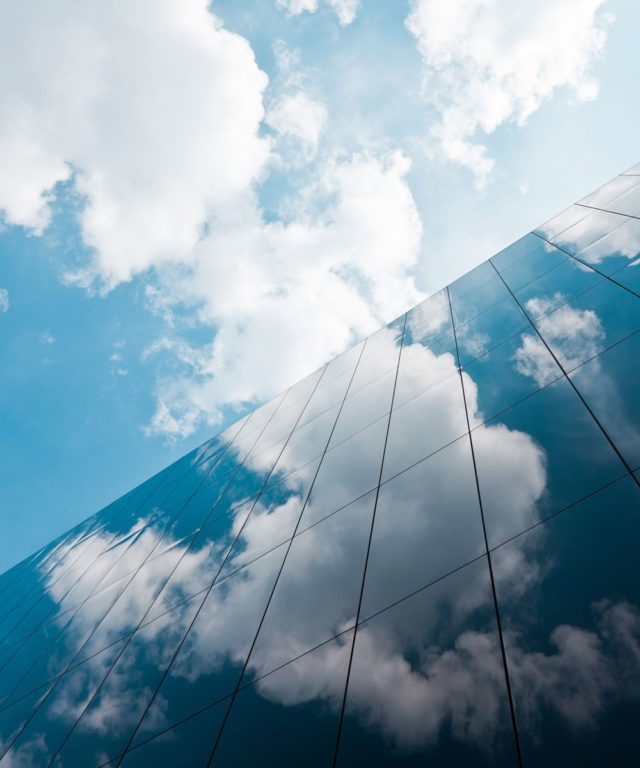 Blue sky and clouds reflecting on building