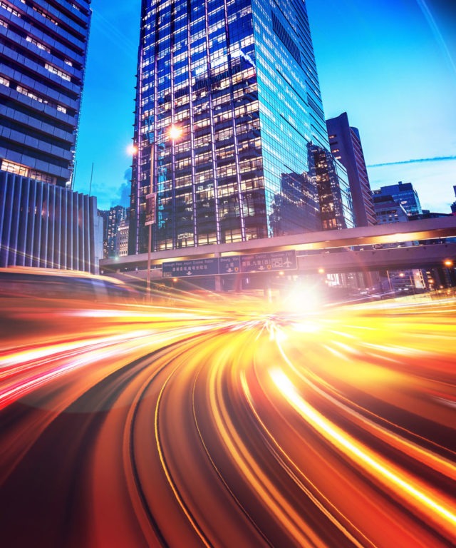 Blurred traffic driving through a city