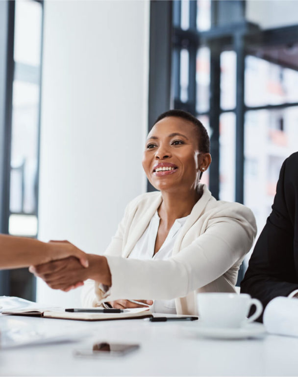 Two businessmen working at a table in a bright office