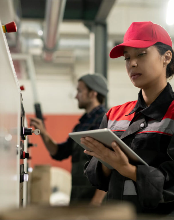 Engineer working on a tablet in a manufacturing plant