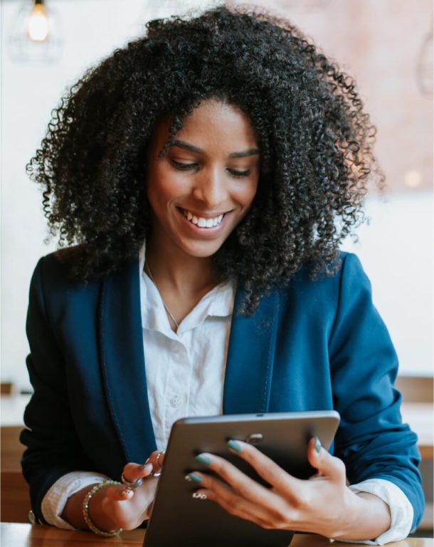 Woman in a suit working on a tablet