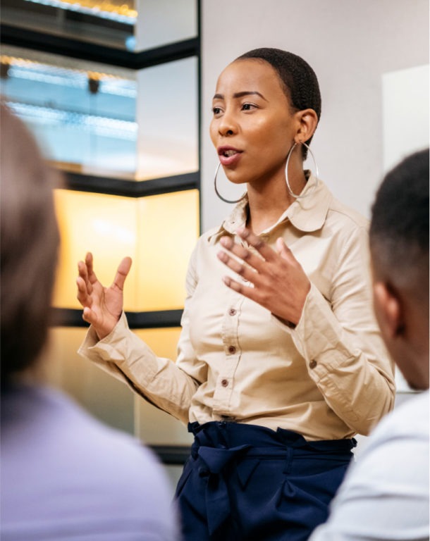 Businesswoman presenting to colleagues in a meeting room