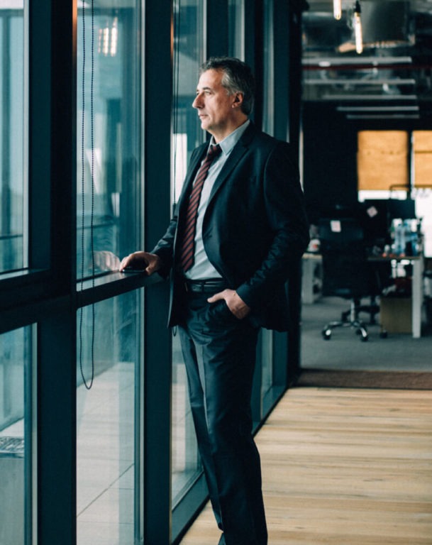 Businessman in suit looking out an office window