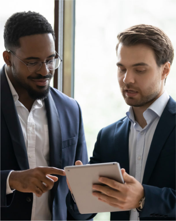 Two men viewing tablet