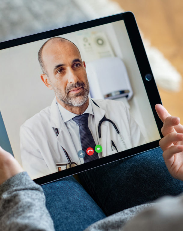 Back view of woman making video call with doctor