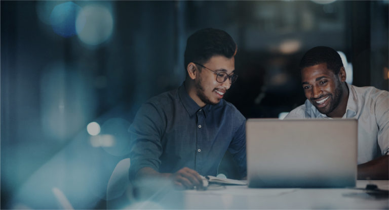 Two men viewing laptop