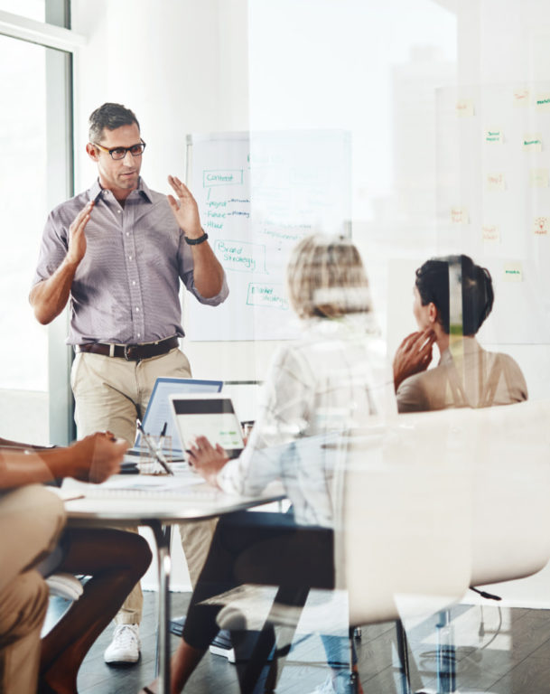 Businessman giving a presentation to his colleagues in an office