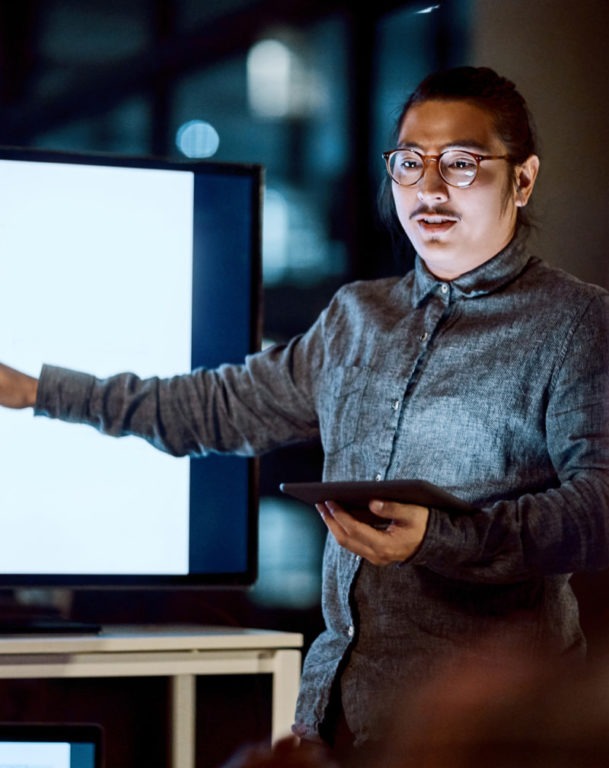 Businessman delivering a presentation during a late night meeting at work