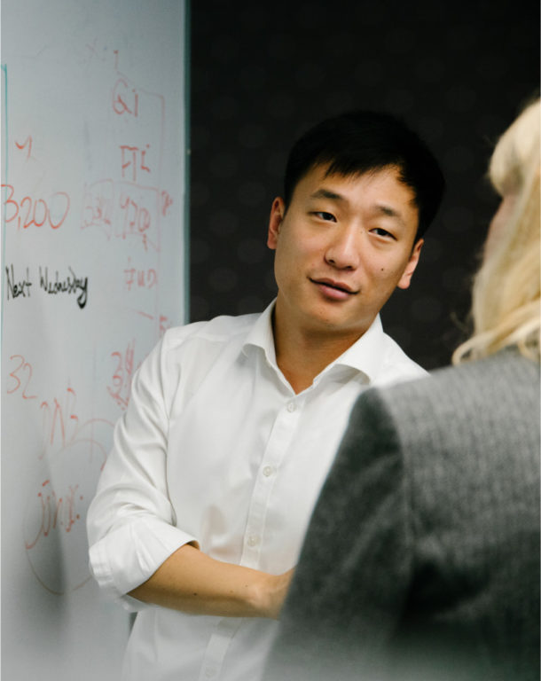 Man and woman in front of whiteboard