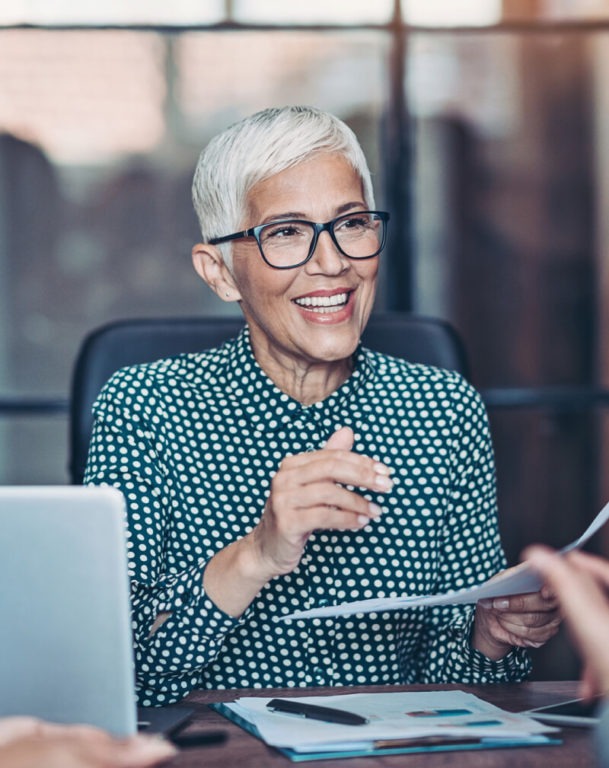 Business woman leading a conversation with two colleagues