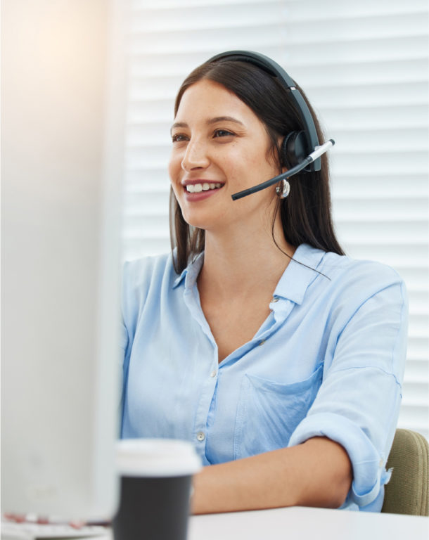 Woman wearing headset in front of computer