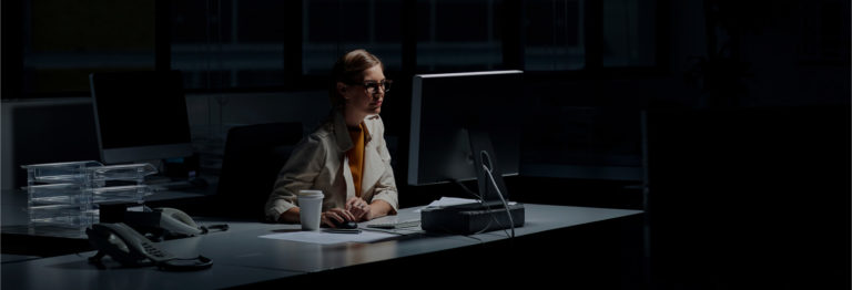 Woman working in a dark office