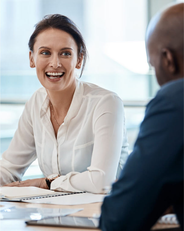 Two coworkers talking in an office