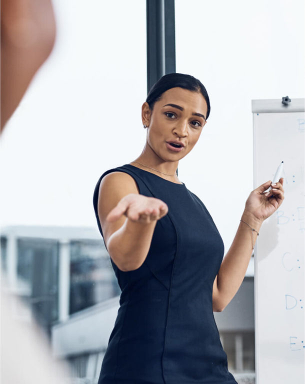 Woman pointing at a coworker while presenting