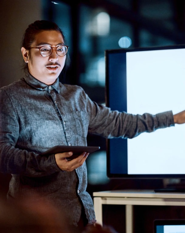 Businessman delivering a presentation during a late night meeting at work