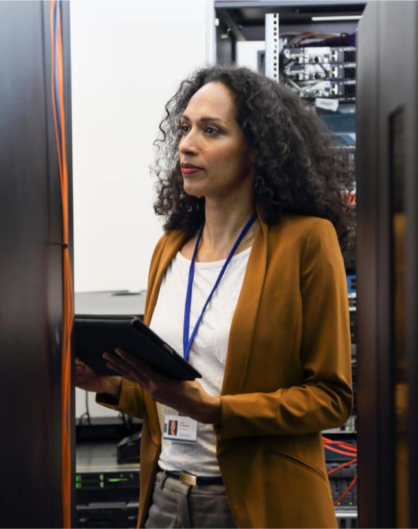 Woman holding a tablet in a data center