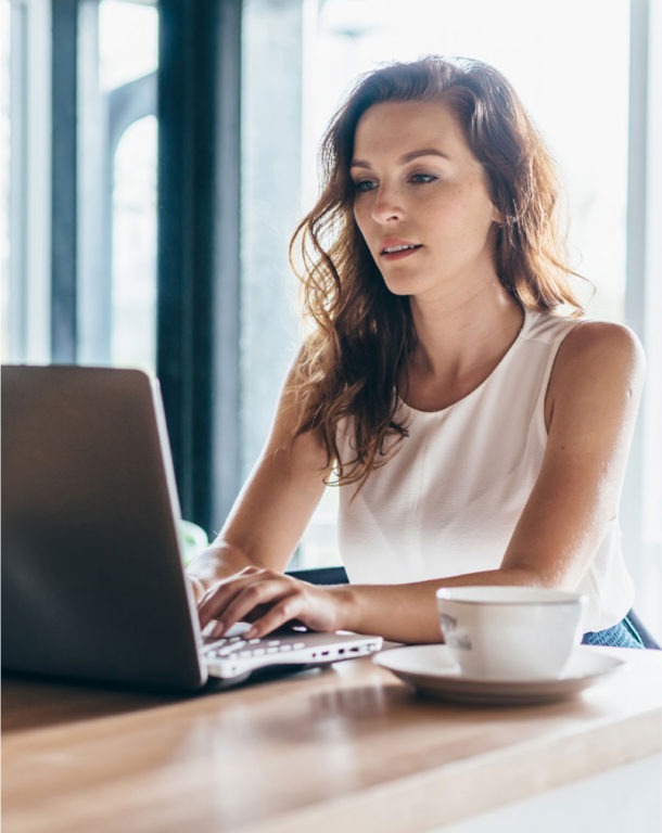 Woman using laptop at table