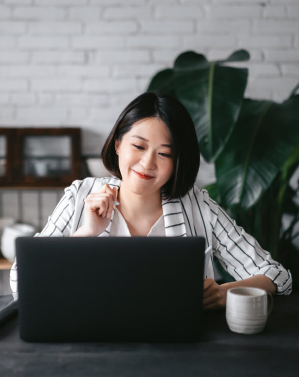 Businesswoman on computer with coffee