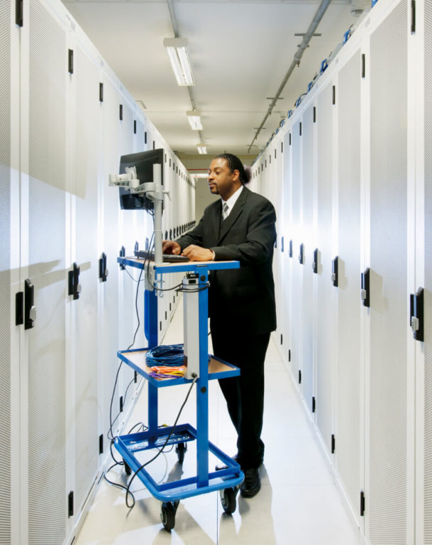 Businessman using a computer in a data center