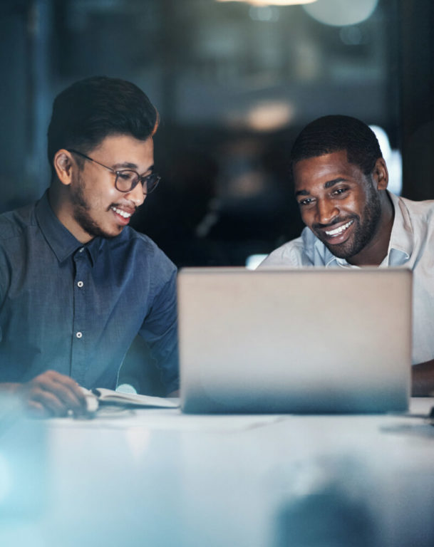 Two coworkers viewing a laptop together