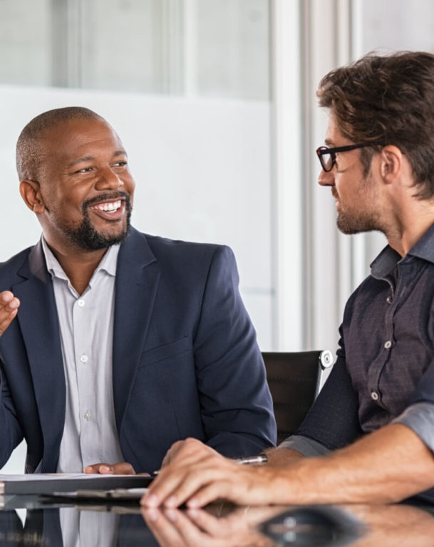 Two coworkers sitting in a conference room