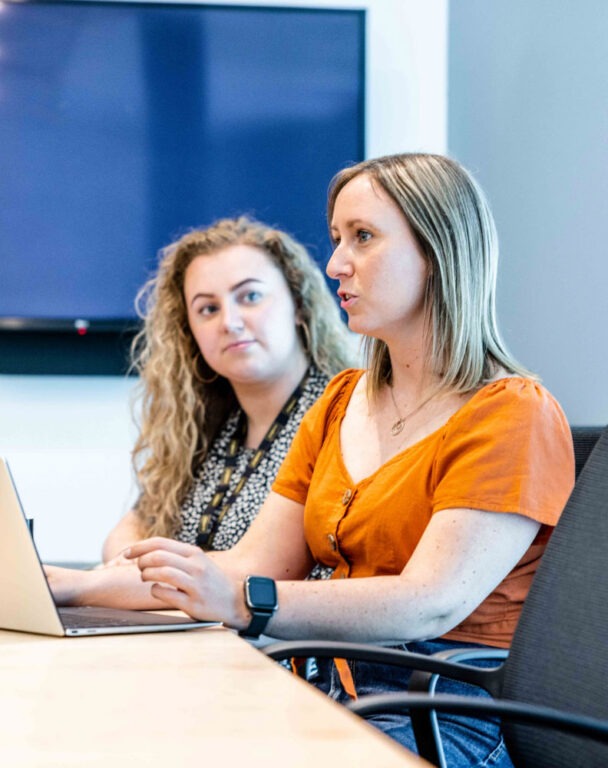 Coworkers talking in bright office