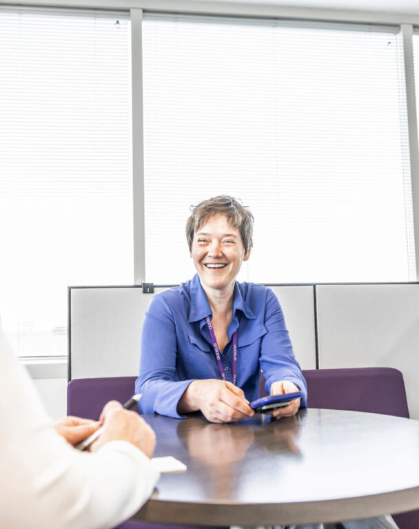 Woman laughing in Ensono office