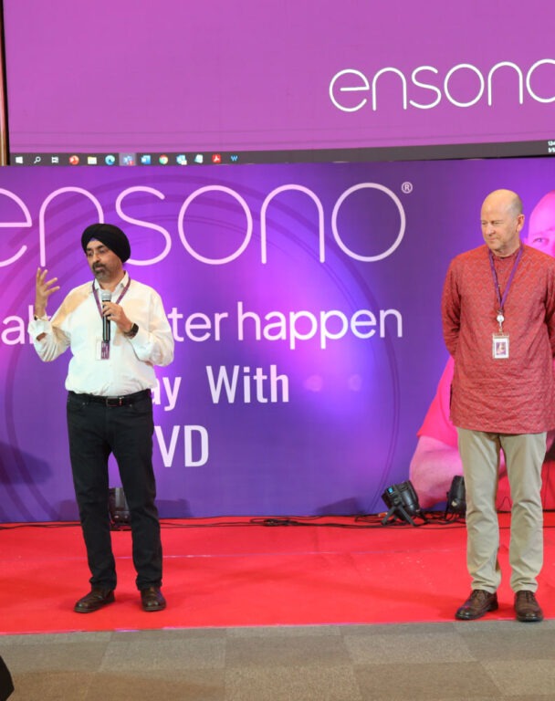 Two Ensono employees speaking at a conference