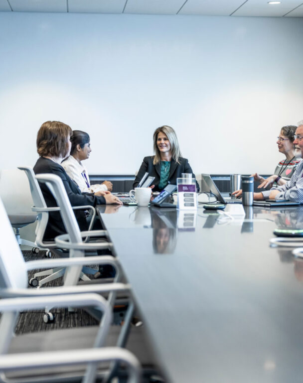 Ensono employees at a conference table