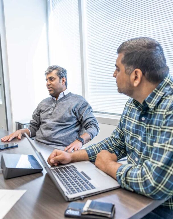 Two coworkers talking in a conference room