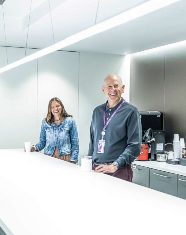 Two employees smiling in a bright office