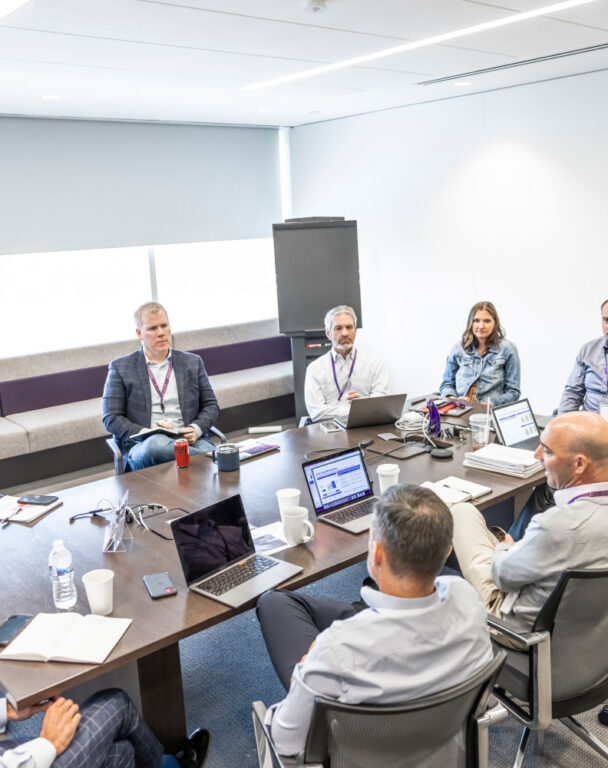 Ensono employees sitting around a conference table