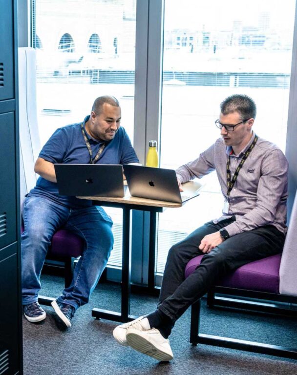 Two coworkers on laptop