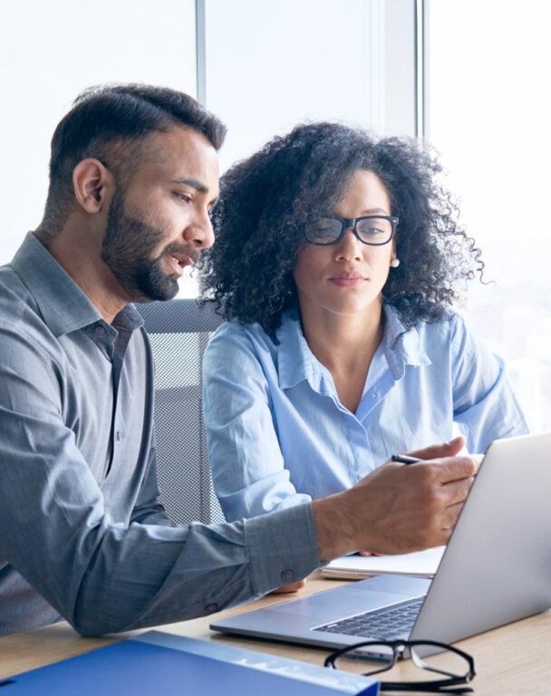 Two people working on a laptop