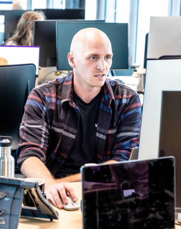 Person working on desktop computer in office